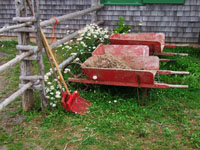 old wheelbarrows against fence