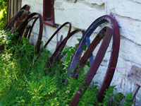 old wagon wheels against side of building