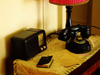 1930s sidetable with antique phone and antique radio