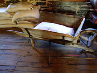 vintage wheelbarrow in gristmill