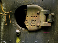 broken and rusted door on a boiler